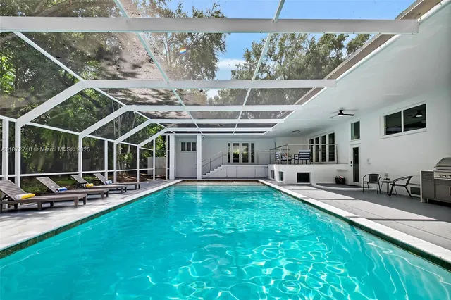 a view of a house with backyard sitting area and furniture