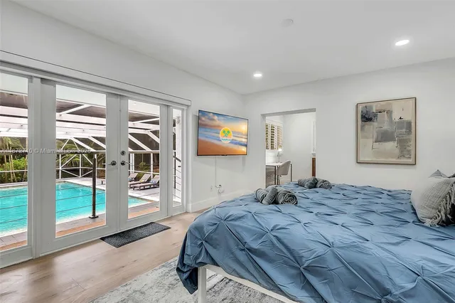 a bedroom with a large bed and a window