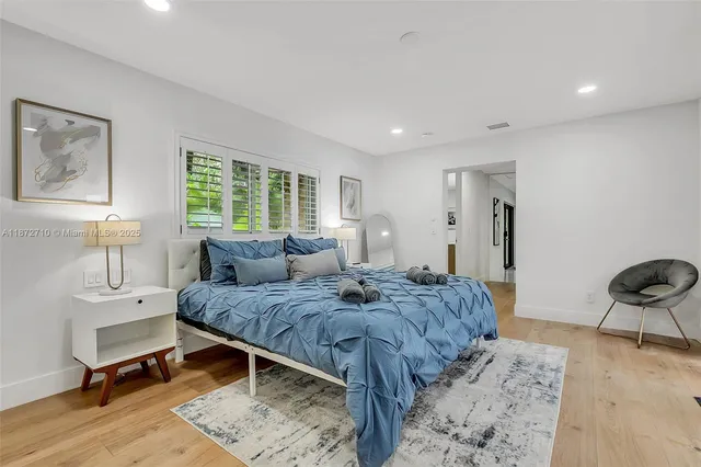a spacious bedroom with a bed and a cabinets
