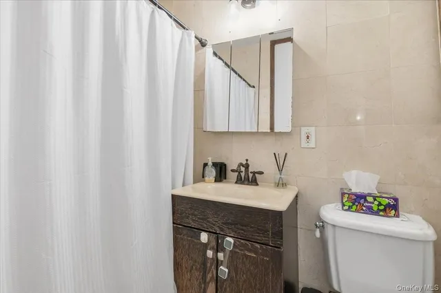 a bathroom with a sink toilet vanity and tub