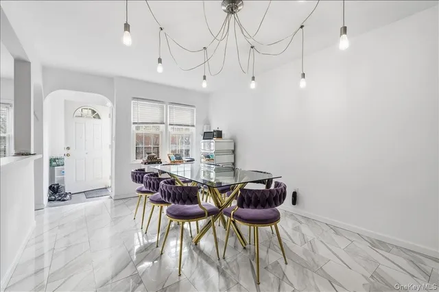 a view of a dining room with furniture and a chandelier