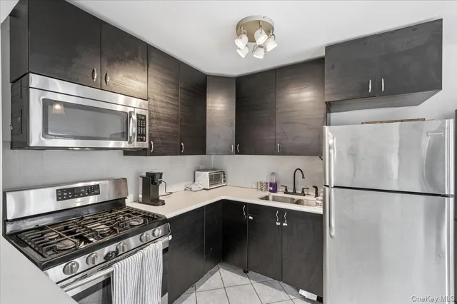 a kitchen with a sink a stove and refrigerator