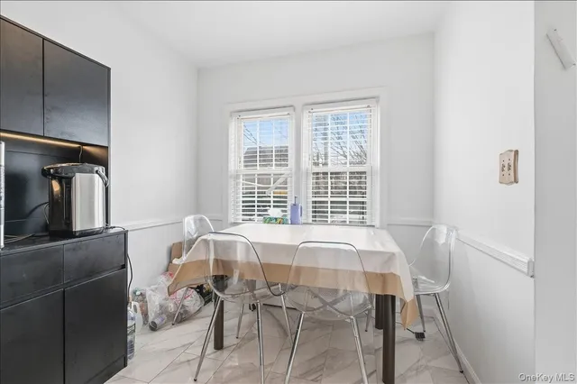 a view of a dining room with furniture and window