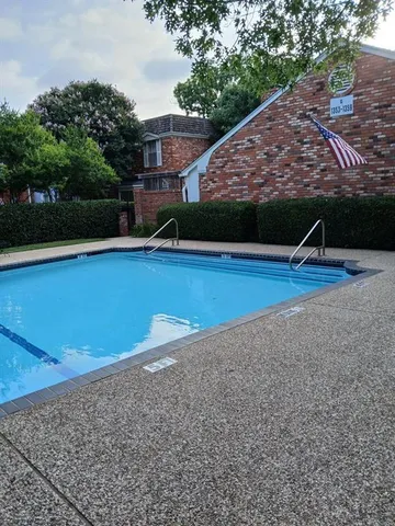 a view of a swimming pool with an outdoor space and seating area