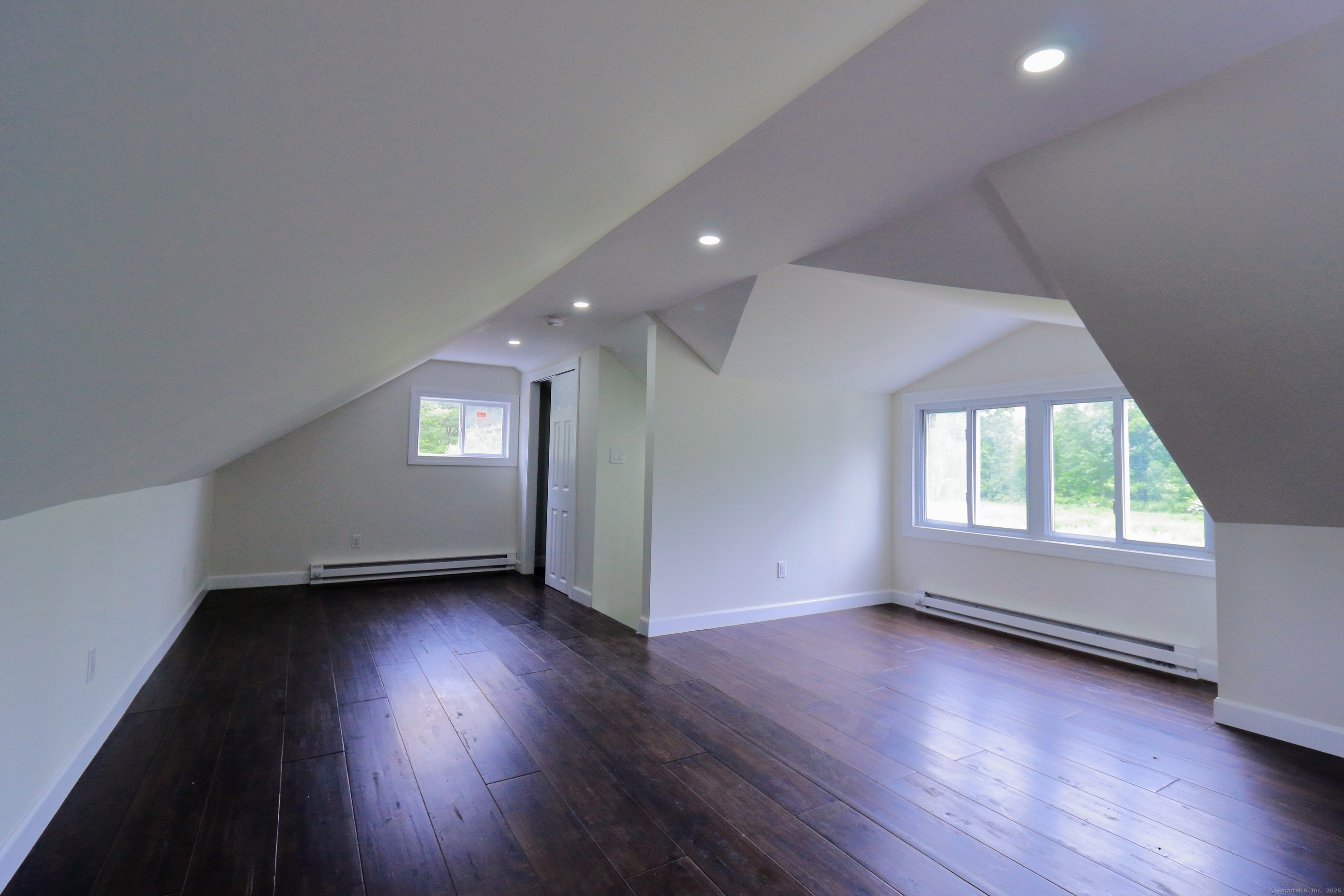 618 Beach Street Goshen, CT 06756 - Photo 13 of 25 an empty room with wooden floor and windows
