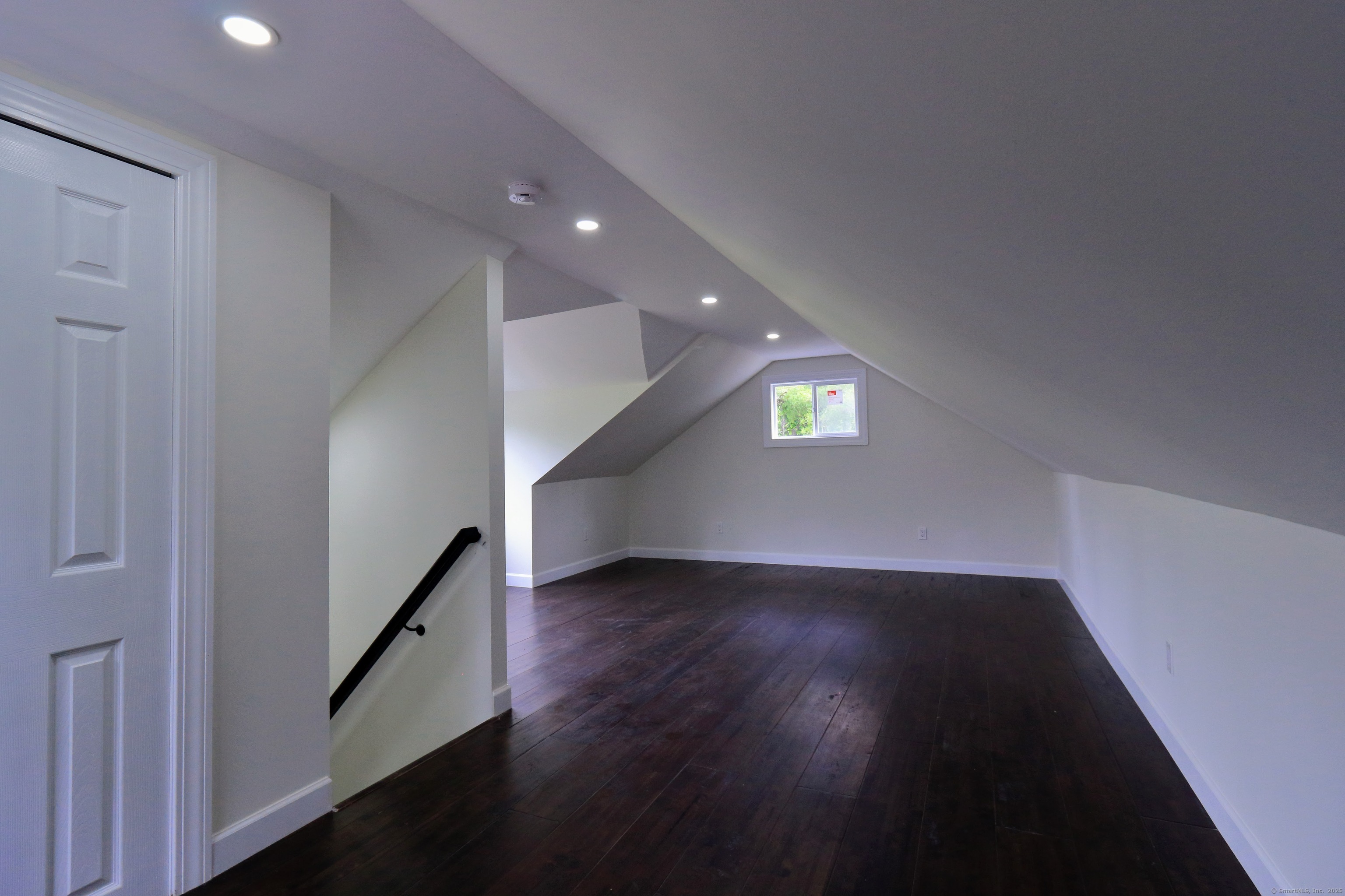 618 Beach Street Goshen, CT 06756 - Photo 14 of 25 an empty room with wooden floor and windows