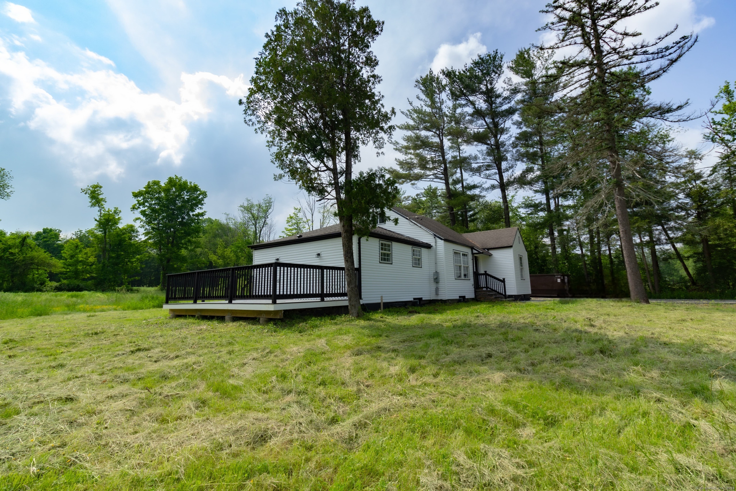 618 Beach Street Goshen, CT 06756 - Photo 15 of 25 a view of a house with a yard and a large tree