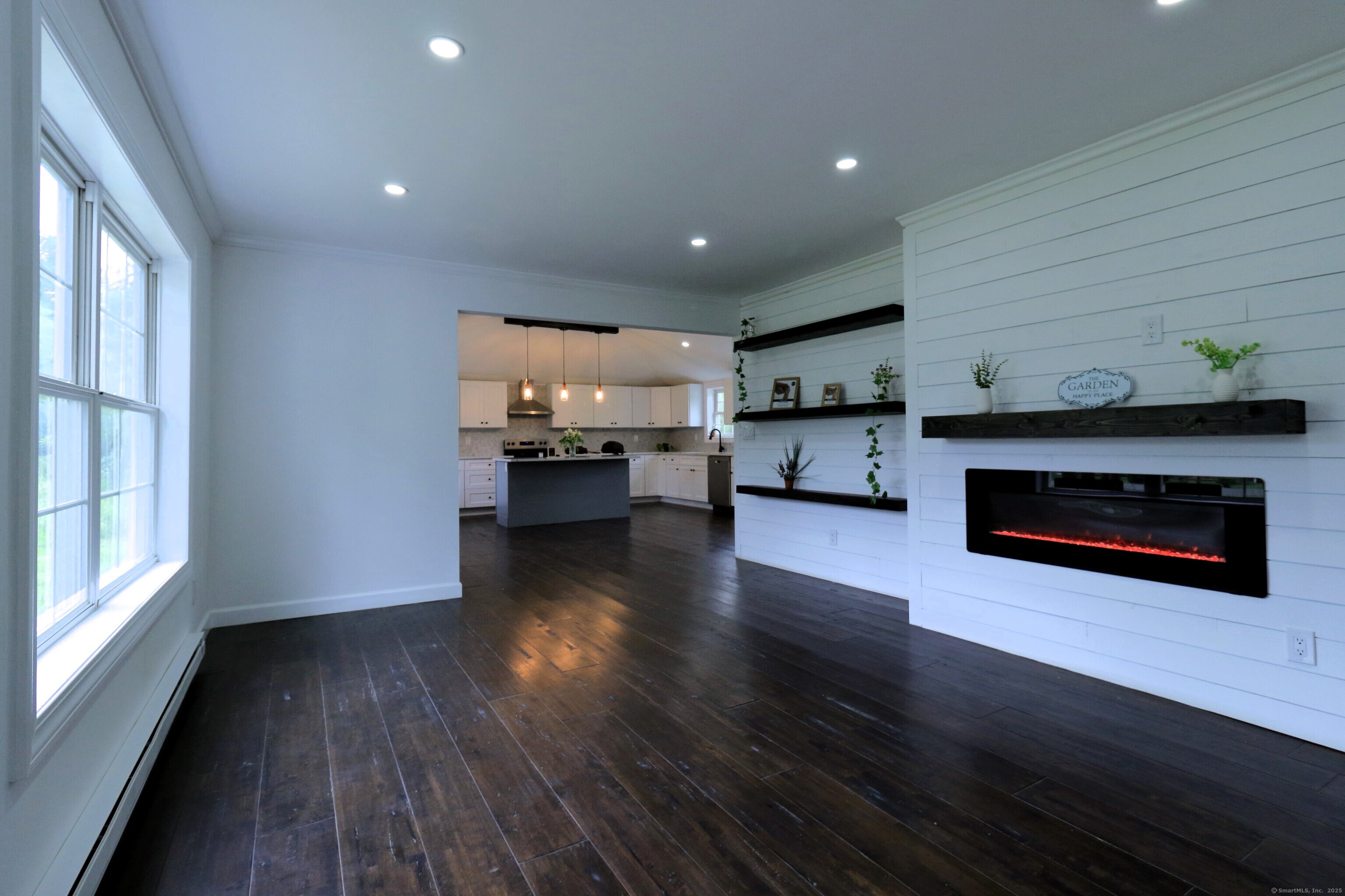 618 Beach Street Goshen, CT 06756 - Photo 2 of 25 a living room with stainless steel appliances wooden floor and a kitchen view