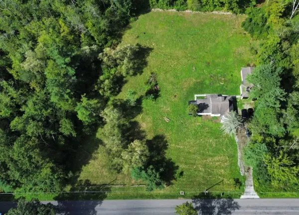 an aerial view of a house with a yard