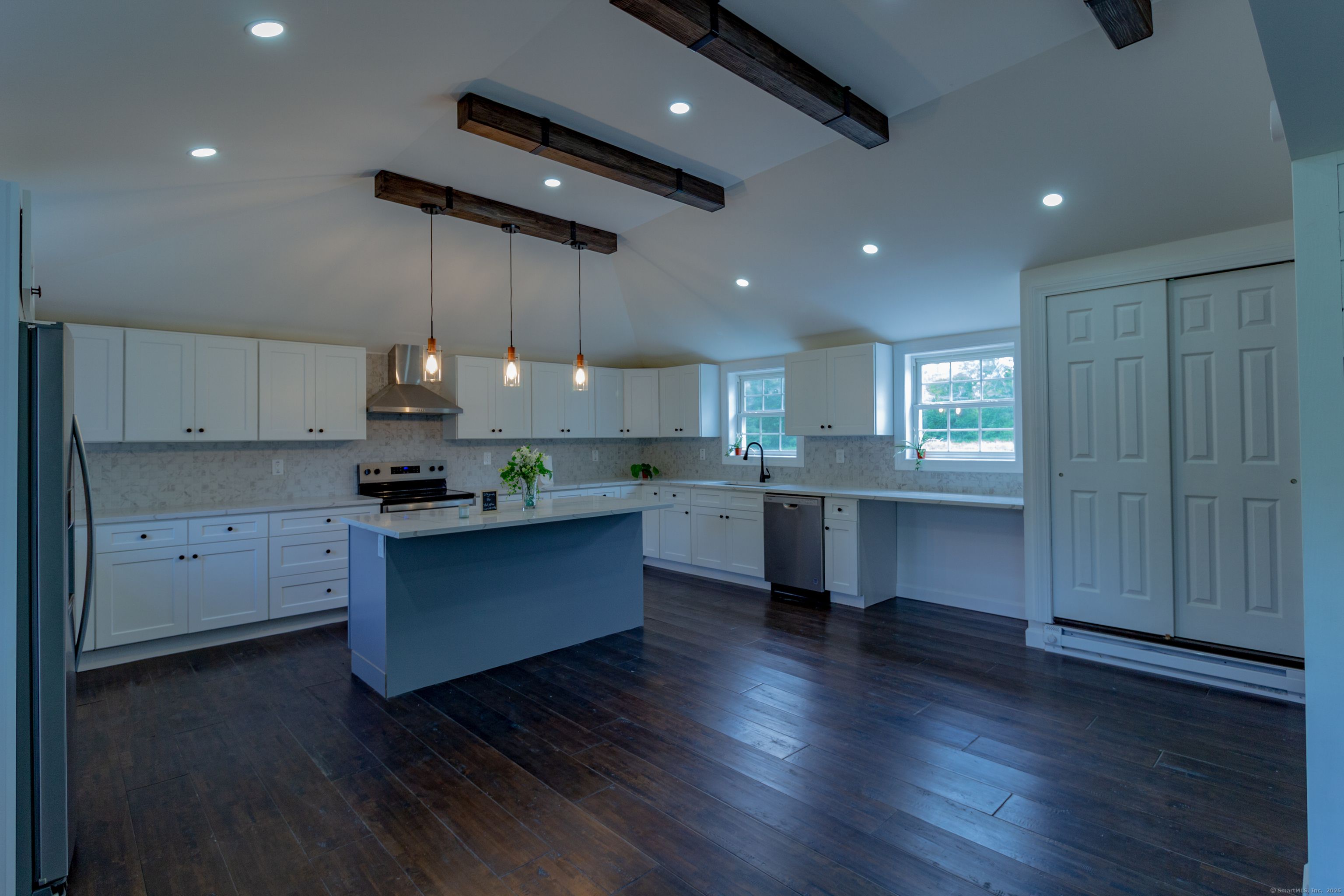 618 Beach Street Goshen, CT 06756 - Photo 3 of 25 a kitchen with stainless steel appliances granite countertop a sink cabinets and wooden floor