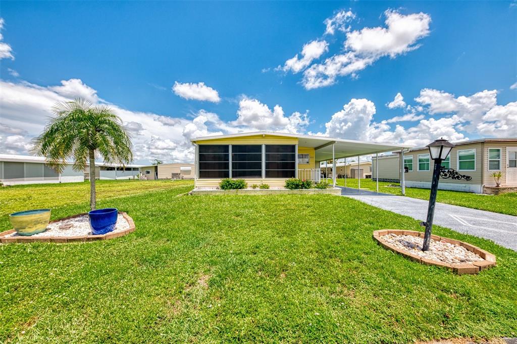 a view of a house with a backyard porch and sitting area