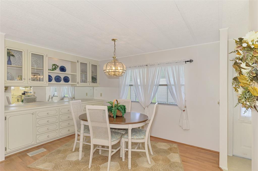 322 Robalo North Port, FL 34287 - Photo 12 of 57 a view of a dining room with furniture and wooden floor