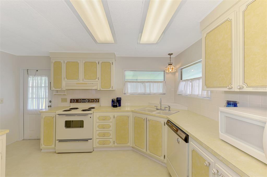 322 Robalo North Port, FL 34287 - Photo 15 of 57 a kitchen with white cabinets and white appliances