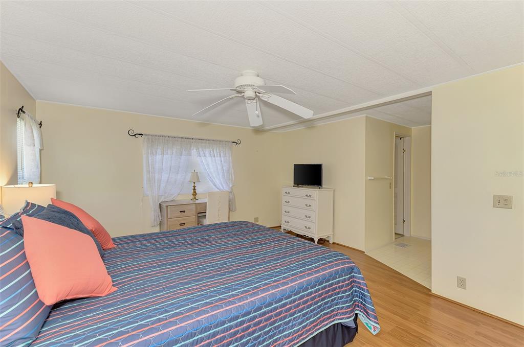 322 Robalo North Port, FL 34287 - Photo 19 of 57 a bedroom with a bed and a closet with wooden floor