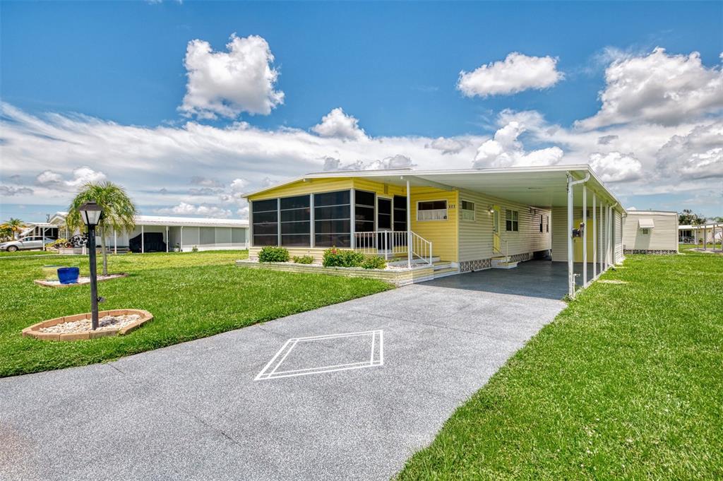 322 Robalo North Port, FL 34287 - Photo 2 of 57 a view of a house with a yard and potted plants