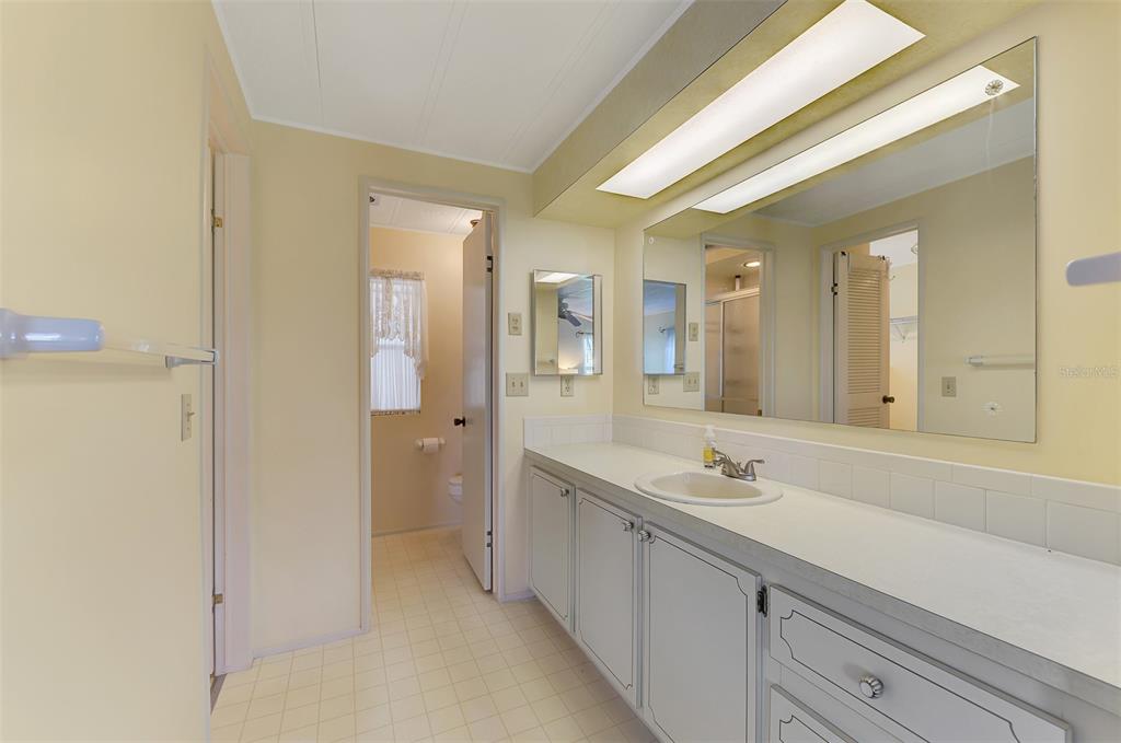 322 Robalo North Port, FL 34287 - Photo 22 of 57 a spacious bathroom with a shower sink and mirror