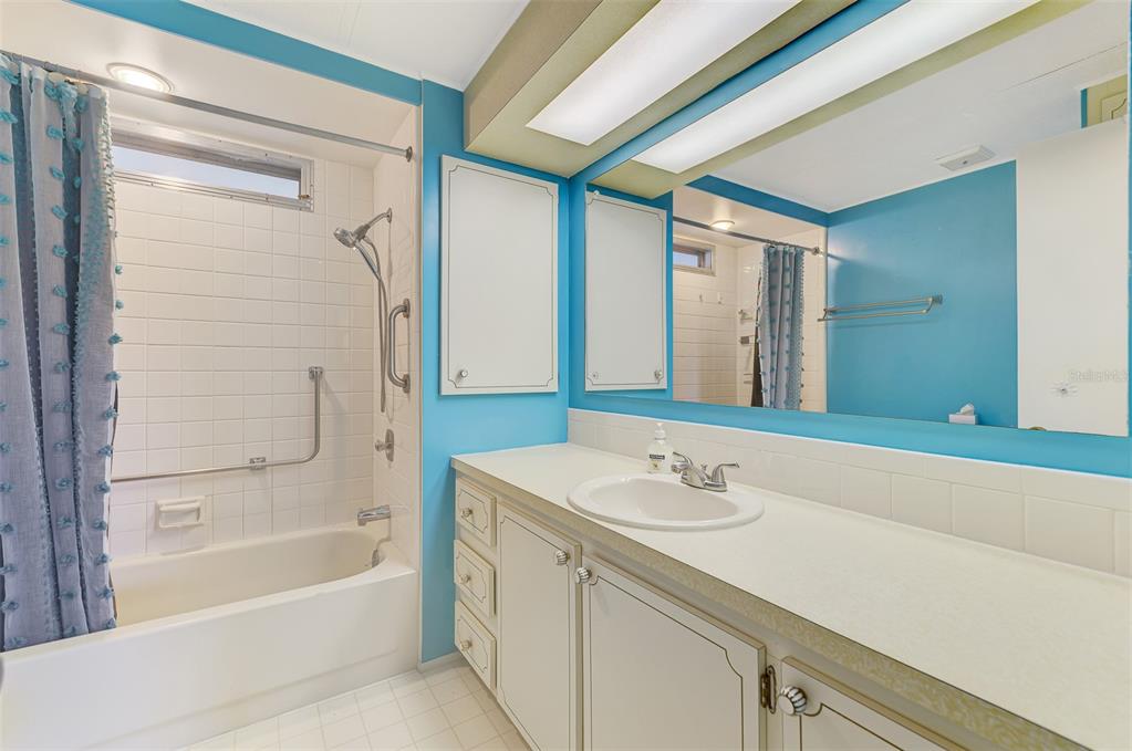 322 Robalo North Port, FL 34287 - Photo 27 of 57 a bathroom with a granite countertop sink a mirror a bathtub and shower