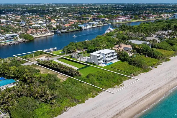 an aerial view of residential houses with outdoor space and river