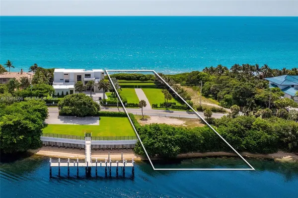 a view of a tennis ground with large trees