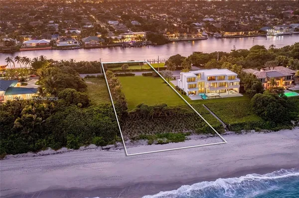 an aerial view of a house with a lake view