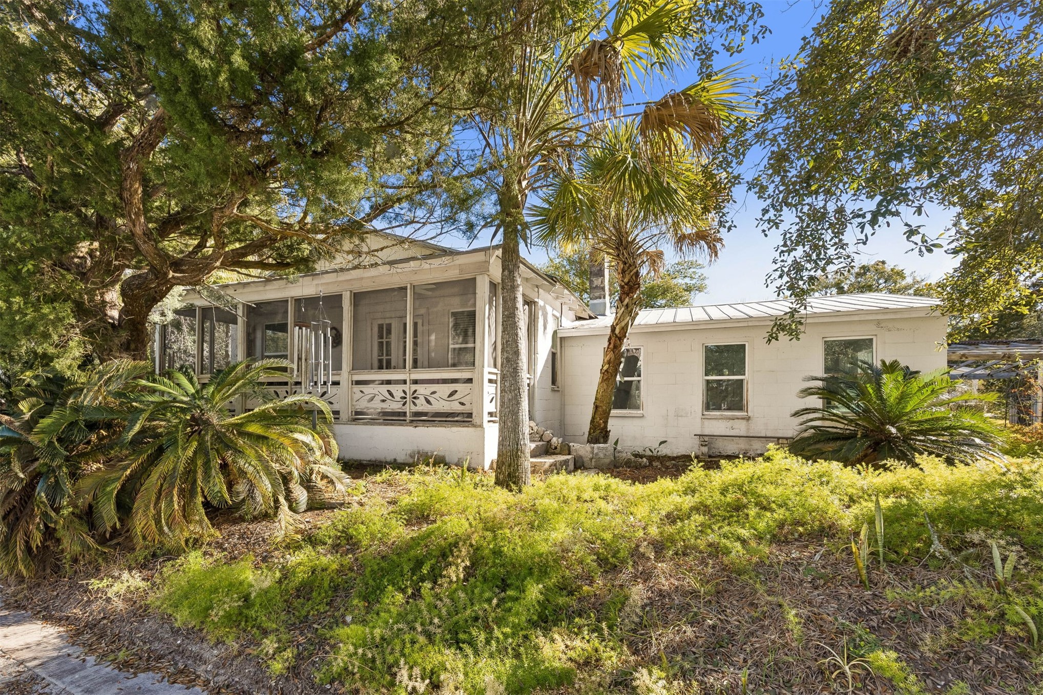 a front view of house with yard and trees around
