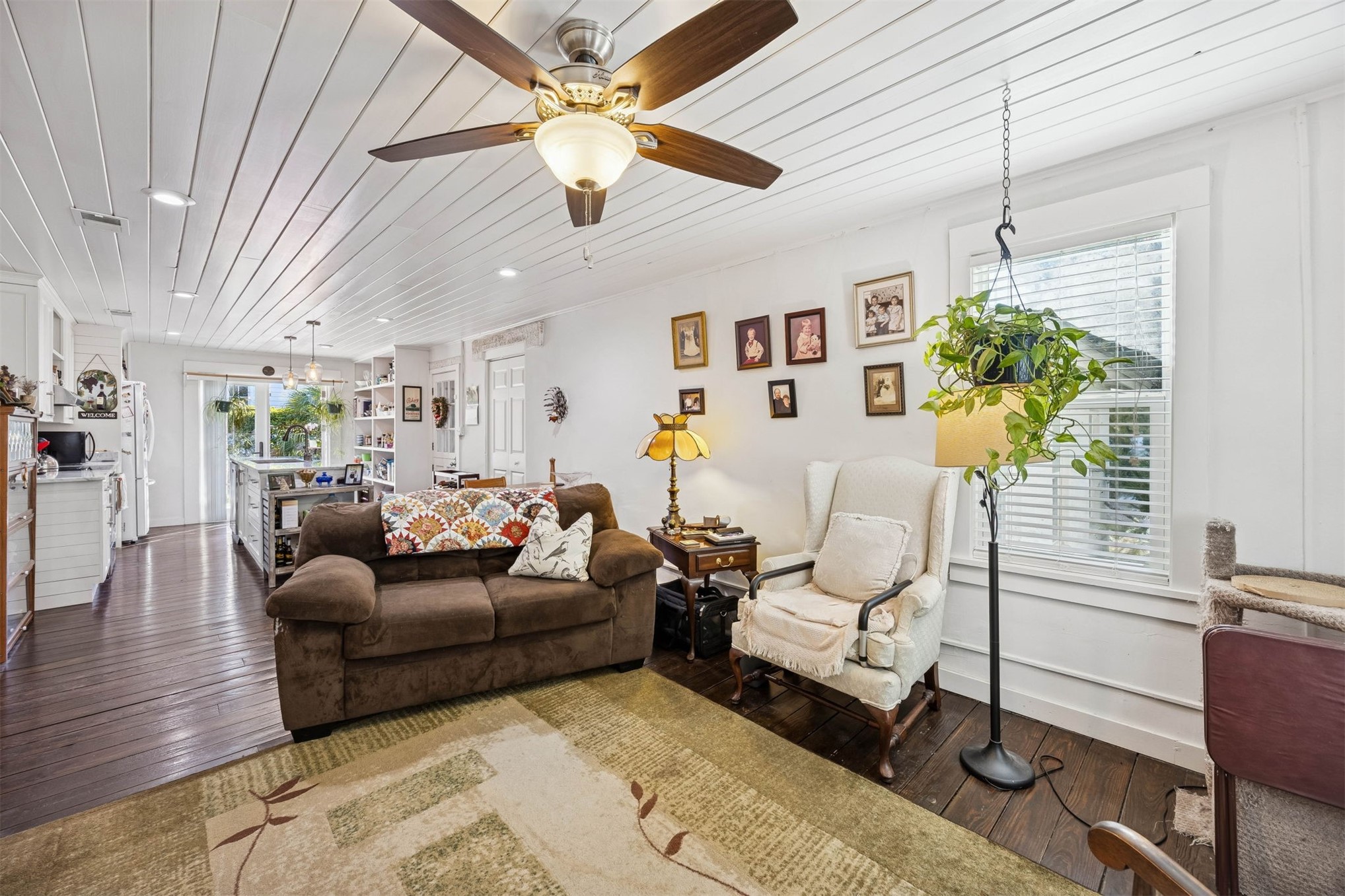 1012 Ladies Street Fernandina Beach, FL 32034 - Photo 17 of 64 a living room with furniture a chandelier and a flat screen tv