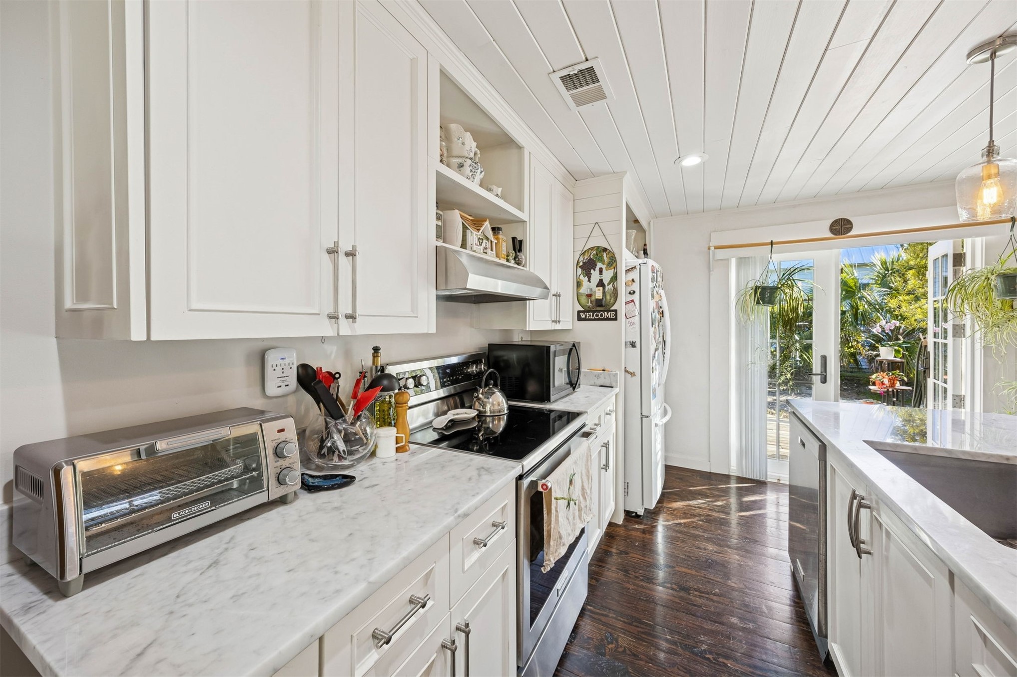 1012 Ladies Street Fernandina Beach, FL 32034 - Photo 24 of 64 a kitchen with stainless steel appliances granite countertop a stove a sink and a refrigerator