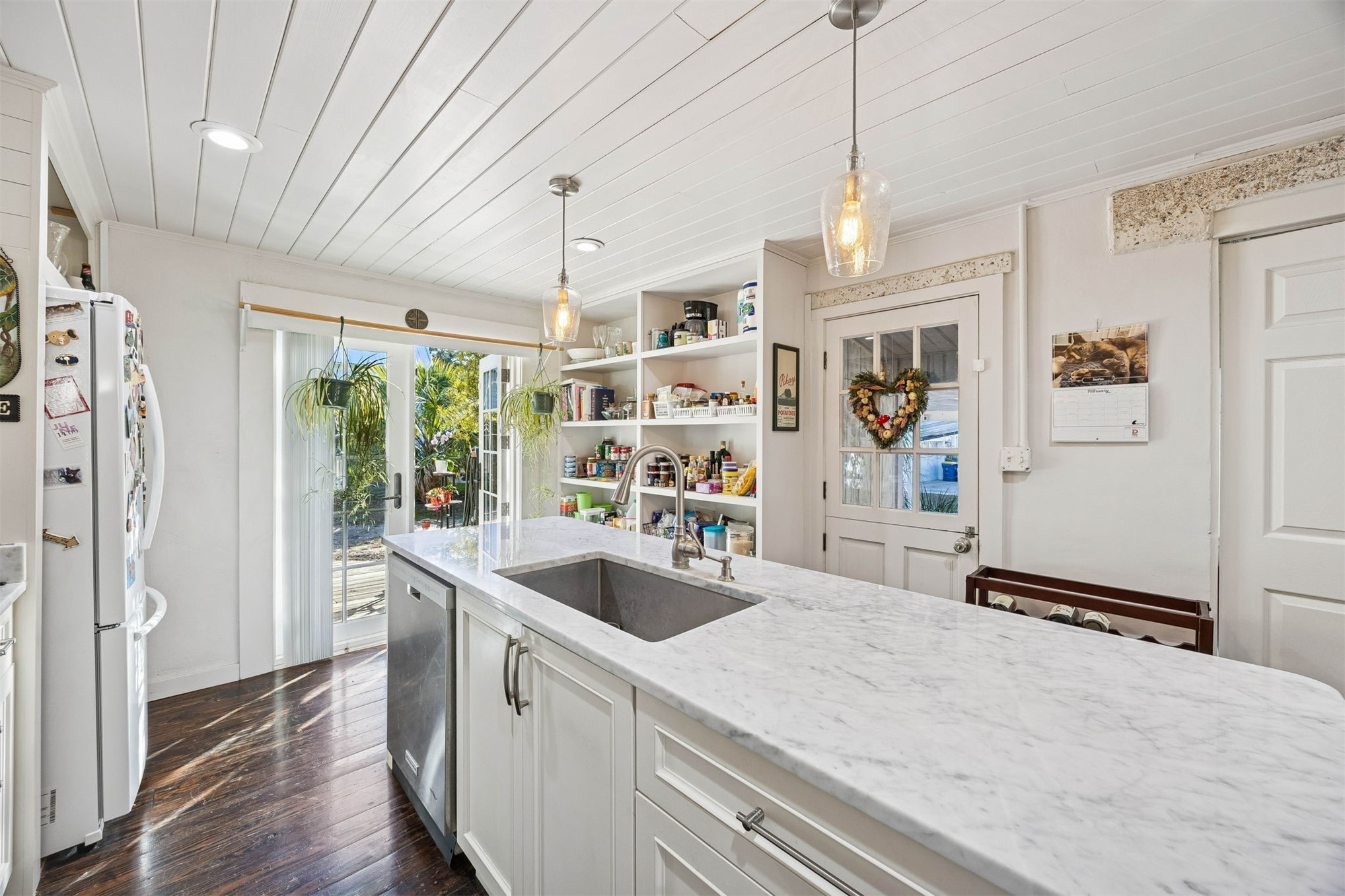 1012 Ladies Street Fernandina Beach, FL 32034 - Photo 25 of 64 a kitchen with stainless steel appliances granite countertop a sink and refrigerator