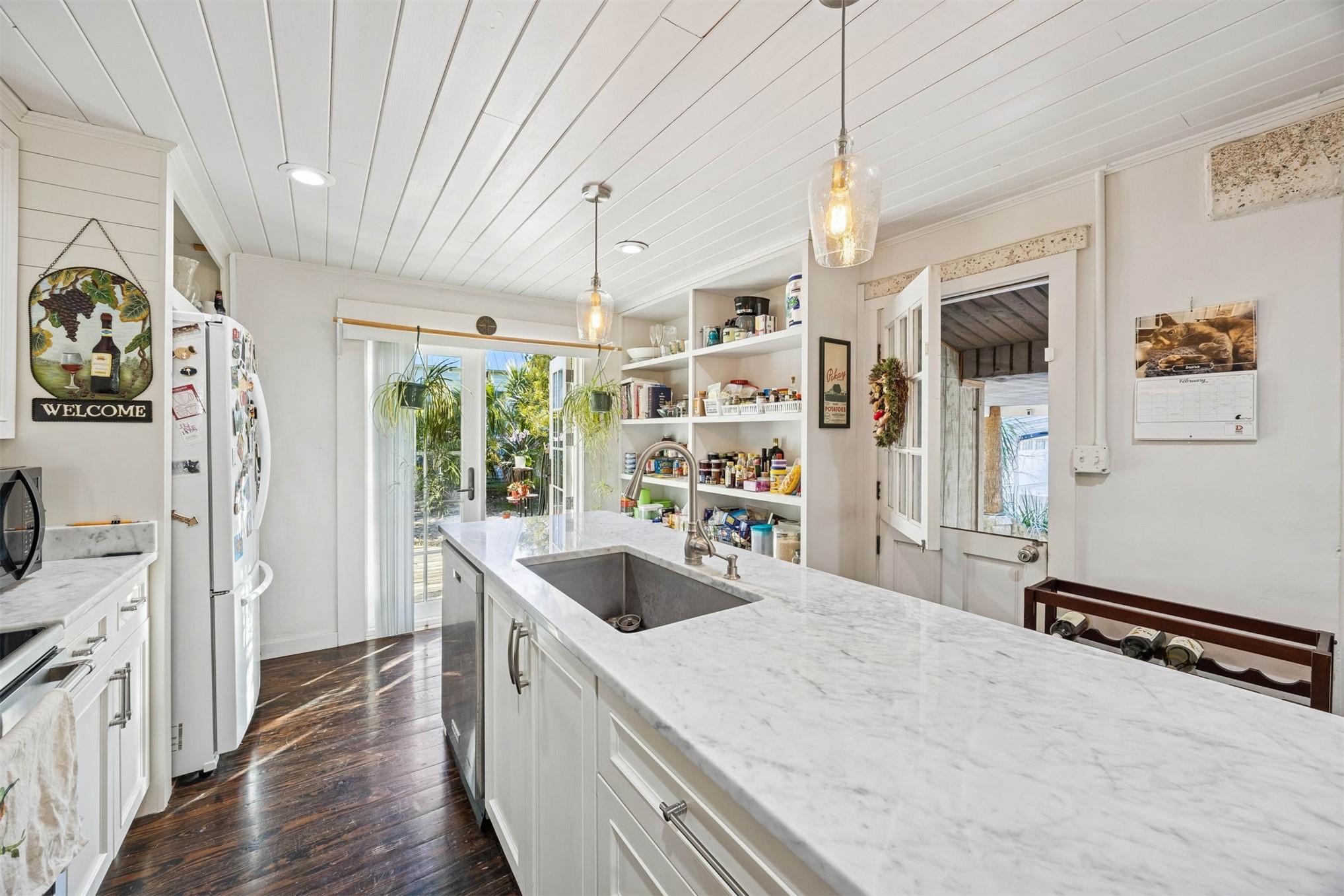 1012 Ladies Street Fernandina Beach, FL 32034 - Photo 26 of 64 a kitchen with stainless steel appliances granite countertop a sink a stove and a wooden floors