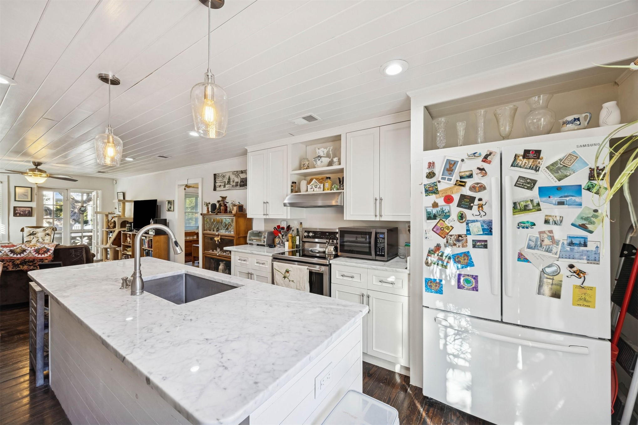 1012 Ladies Street Fernandina Beach, FL 32034 - Photo 27 of 64 a kitchen with stainless steel appliances granite countertop a refrigerator a sink a stove a oven a dining table and chairs with wooden floor