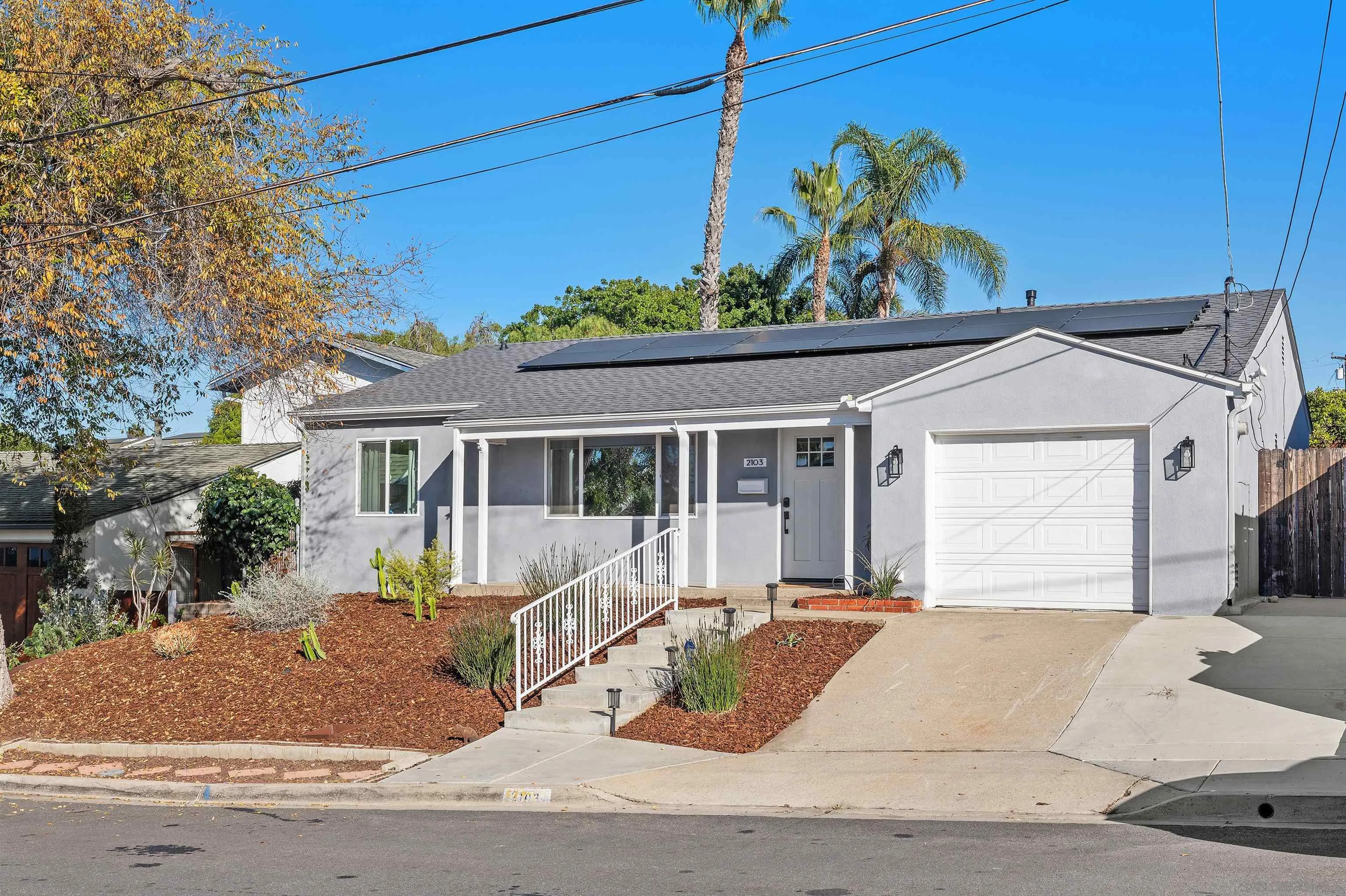 2103 Garfield Road San Diego, CA 92110 - Photo 2 of 34 a view of a house with a bed and potted plants
