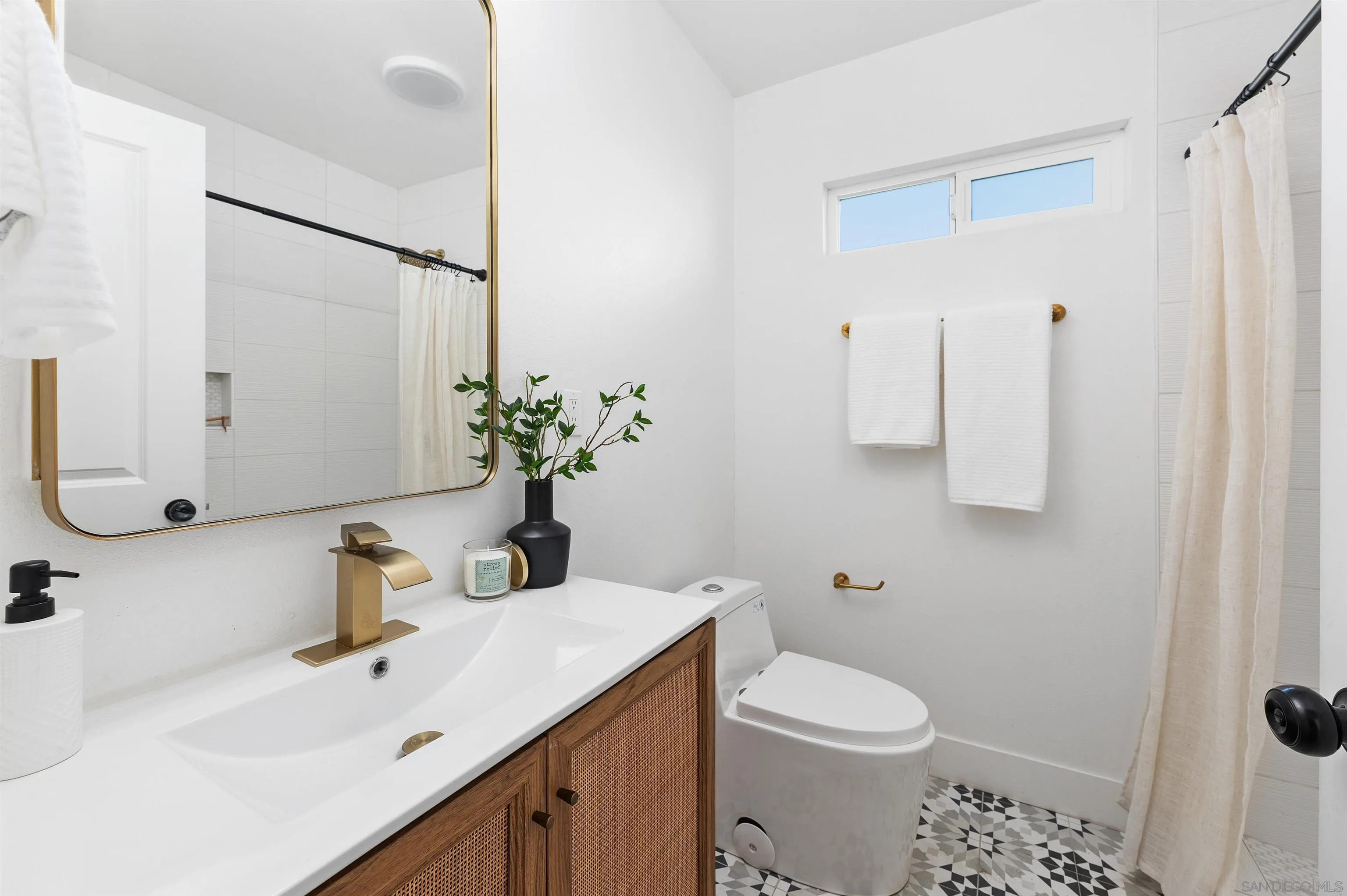 2103 Garfield Road San Diego, CA 92110 - Photo 21 of 34 a bathroom with a sink toilet and shower