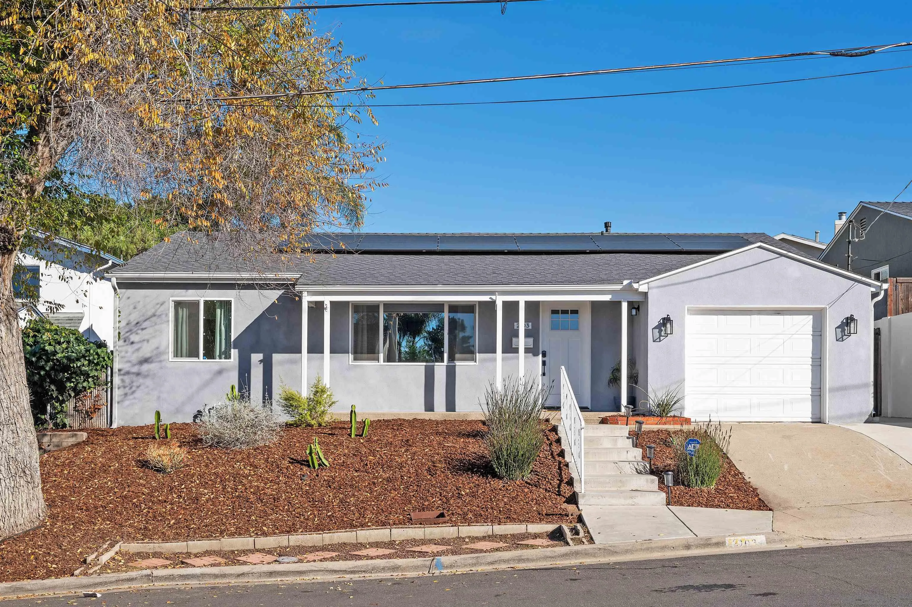 2103 Garfield Road San Diego, CA 92110 - Photo 3 of 34 a front view of a house with a yard and potted plants