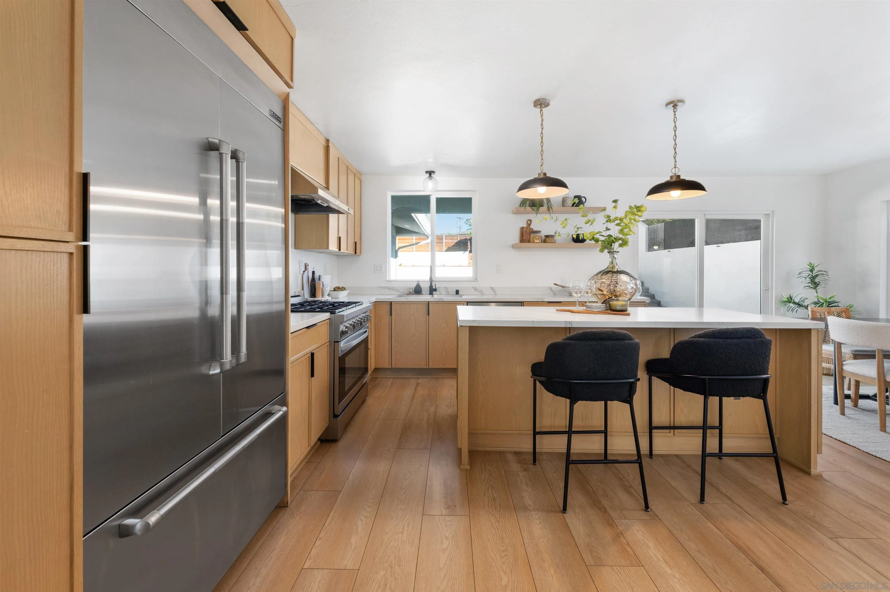 2103 Garfield Road San Diego, CA 92110 - Photo 7 of 34 a kitchen with kitchen island granite countertop a sink cabinets and stainless steel appliances