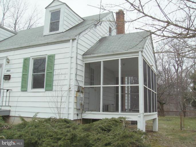 4133 Maple Road Suitland, MD 20746 - Photo 3 of 10 a view of a brick house with a large windows and a large tree