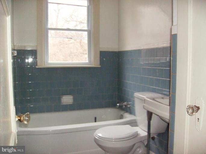 4133 Maple Road Suitland, MD 20746 - Photo 8 of 10 a bathroom with a toilet a sink and bathtub