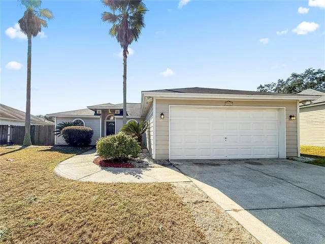 a backyard of a house with yard table and chairs