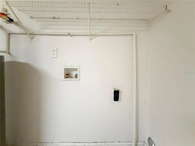 a view of a house with a yard and potted plants