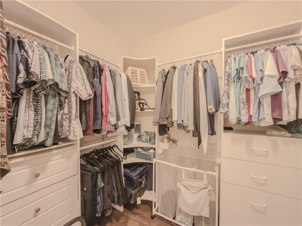 4284 Cedar Bluff Way Southwest Lilburn, GA 30047 - Photo 18 of 62 a view of walk in closet with clothes and shoes