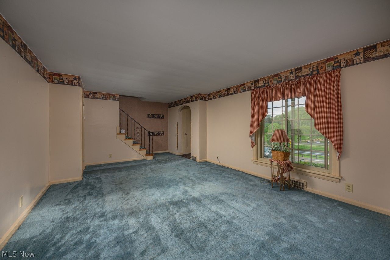 1422 Monument Road Northwest Canton, OH 44703 - Photo 5 of 31 Living room with large picture window, fireplace and carpet flooring