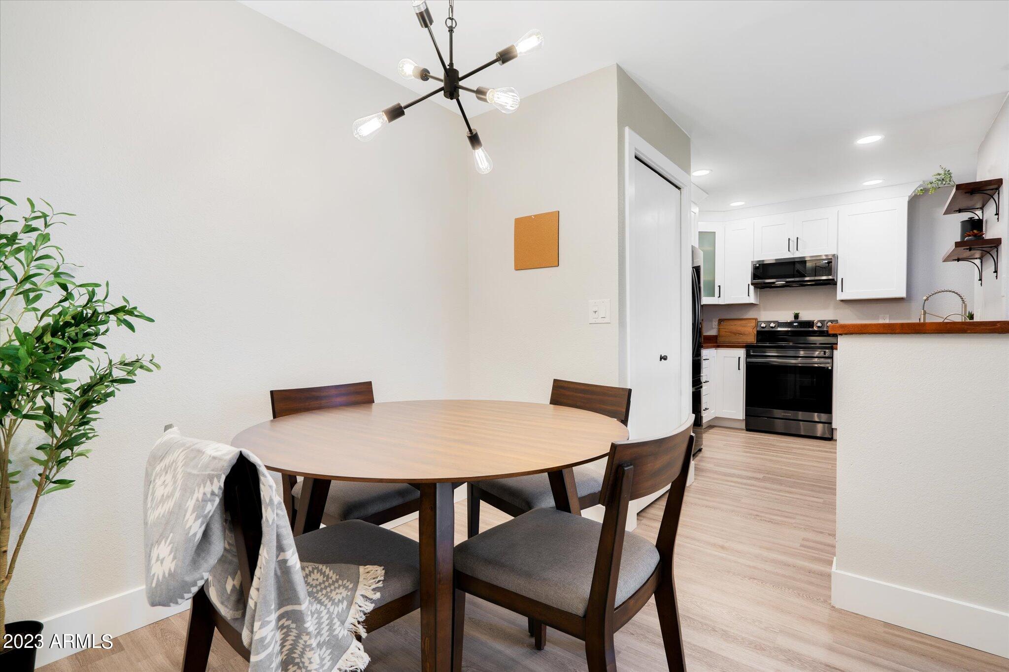 533 West Guadalupe Road, Unit 1024 Mesa, AZ 85210 - Photo 26 of 60 a view of a dining room with furniture and wooden floor