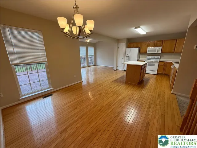 a view of a dining room with furniture wooden floor and chandelier