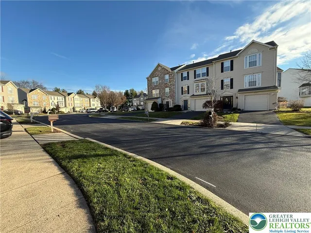 a view of a street with cars parked