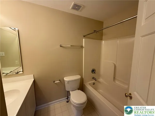 a bathroom with a shower a toilet and a sink