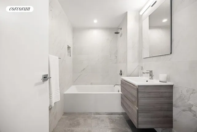 a bathroom with a sink a mirror and a bathtub