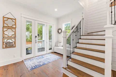 a view of entryway with wooden floor and windows