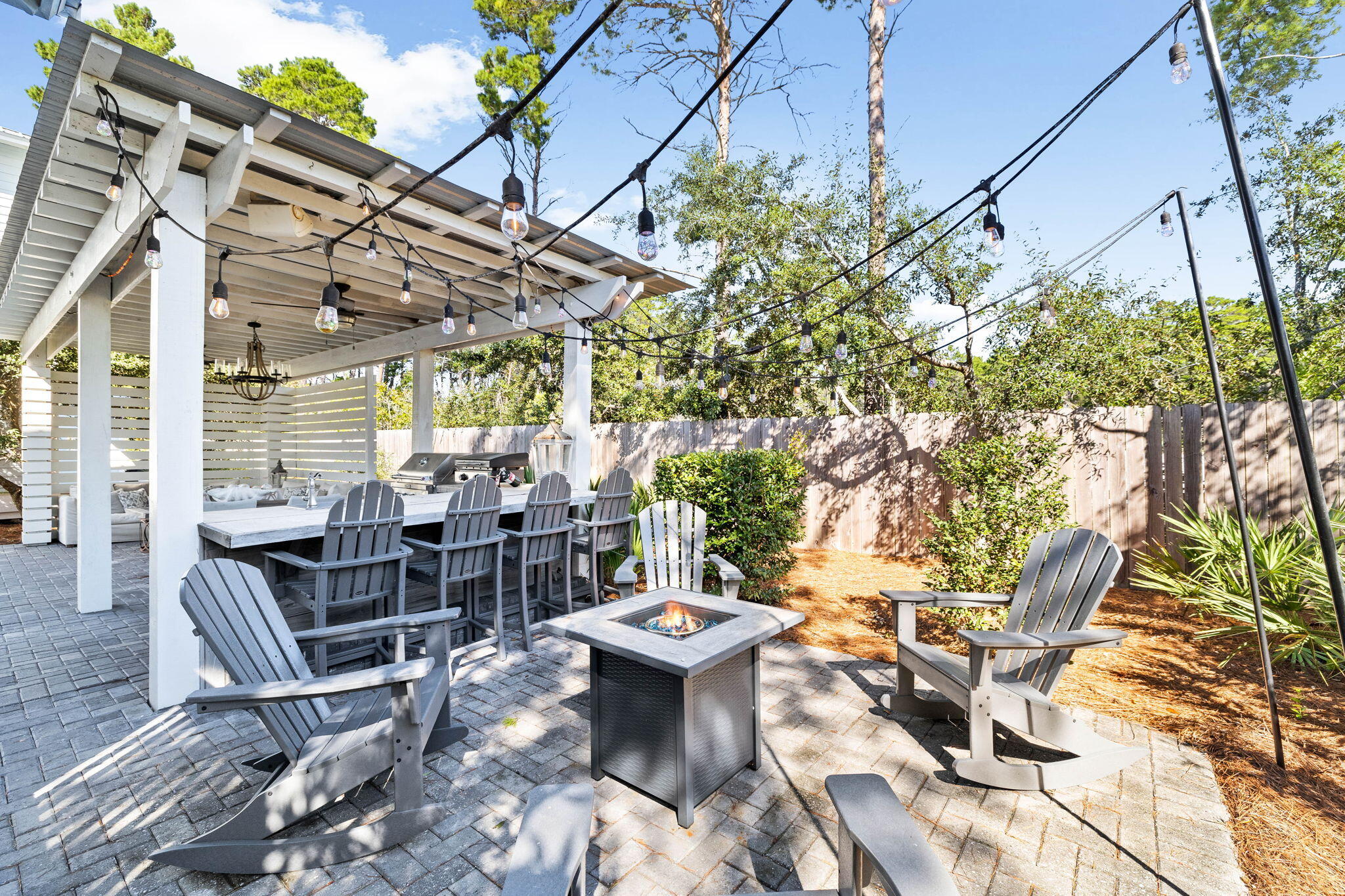 47 Trail Lane Santa Rosa Beach, FL 32459 - Photo 36 of 53 a view of a patio with table and chairs and potted plants