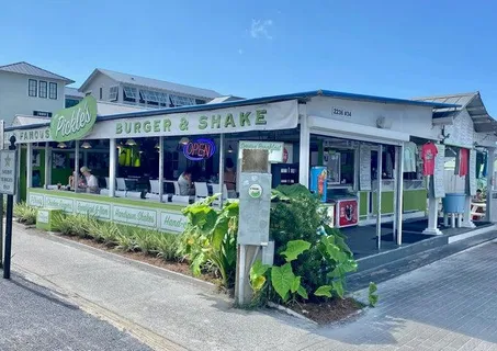 a area with lots of furniture and umbrella
