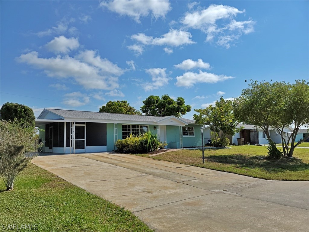 1509 Lindale Circle Lehigh Acres, FL 33936 - Photo 1 of 16 a front view of house with yard and green space