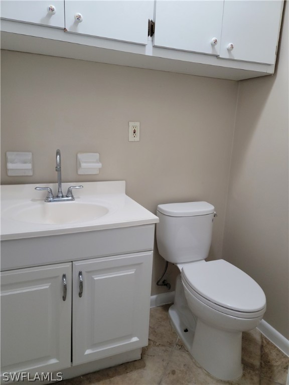 1509 Lindale Circle Lehigh Acres, FL 33936 - Photo 14 of 16 a bathroom with a toilet sink and mirror
